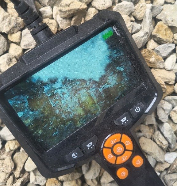 Borescope camera used to inspect a concealed area during a Level 3 Building Survey